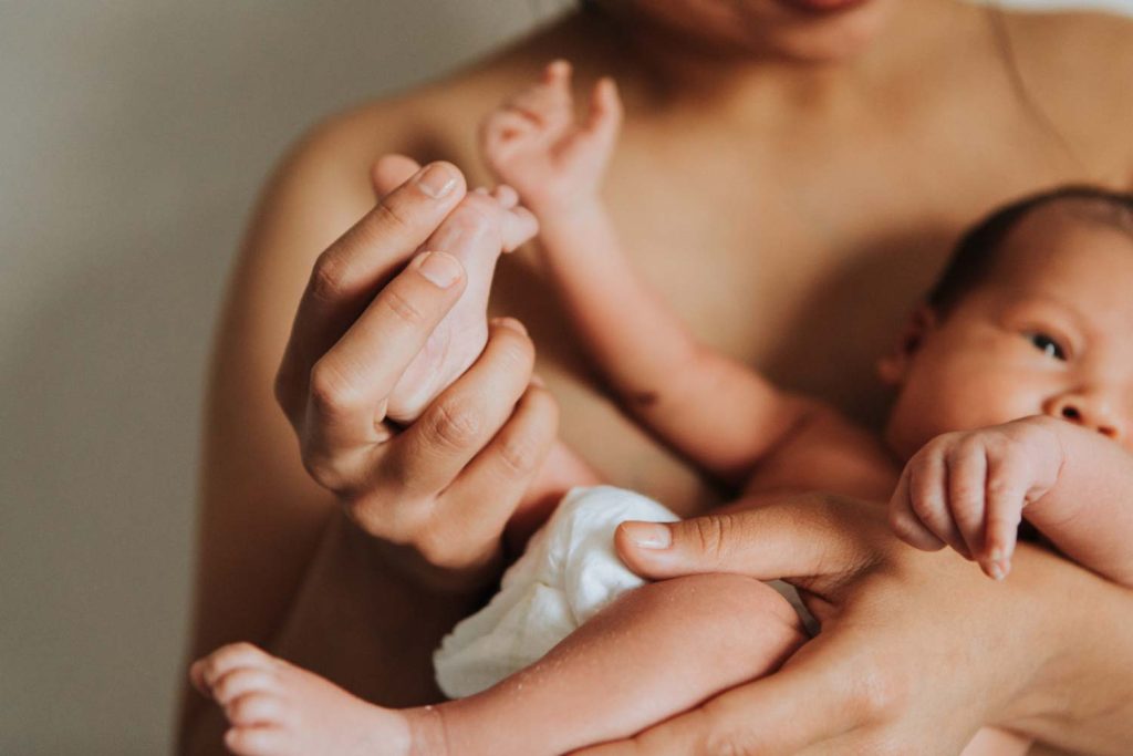 Parent holding newborn baby